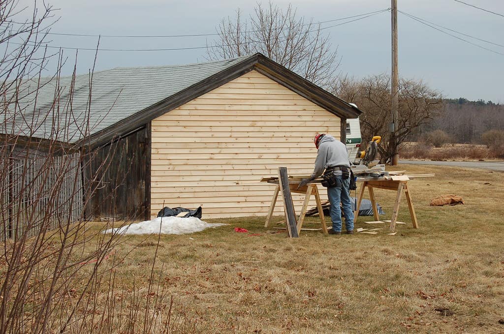 A professional on a shed building repair