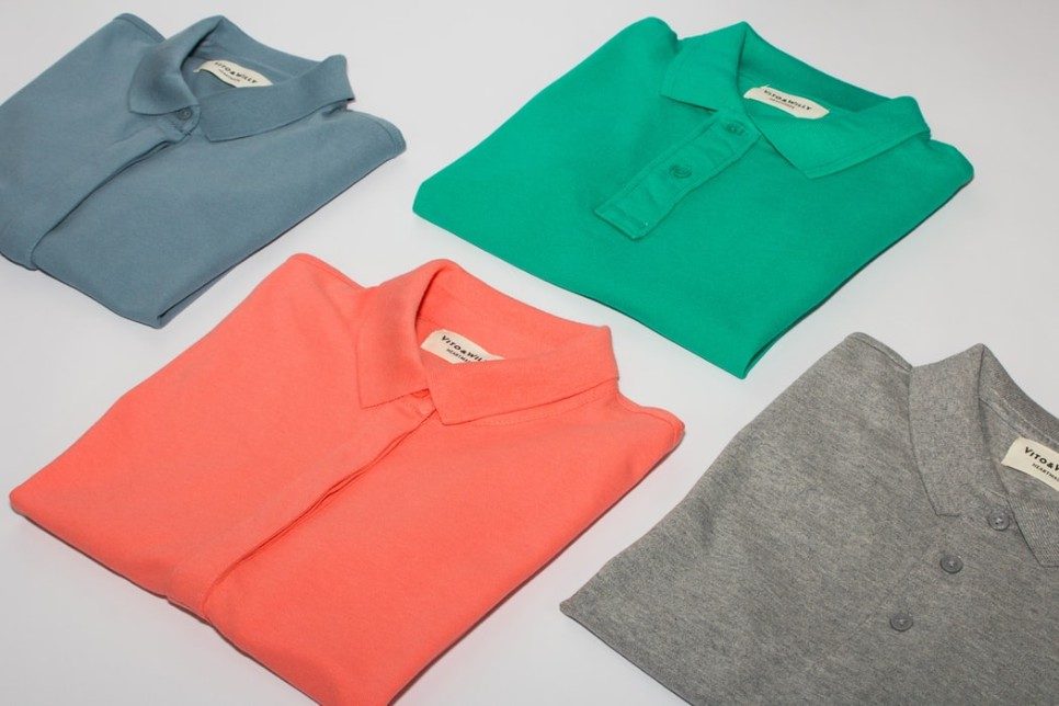 coloured shirts folded on a grey background