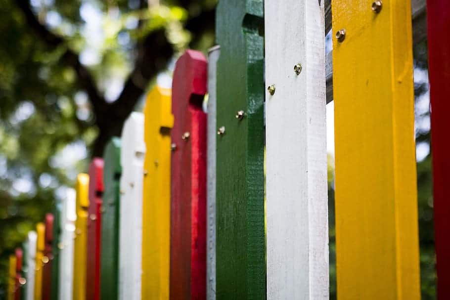 Newly painted garden fences in various vibrant colours
