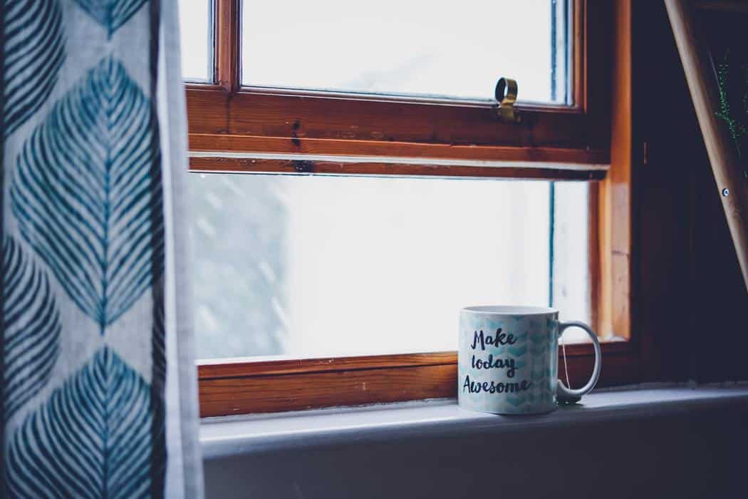 Open window with a mug and curtains 