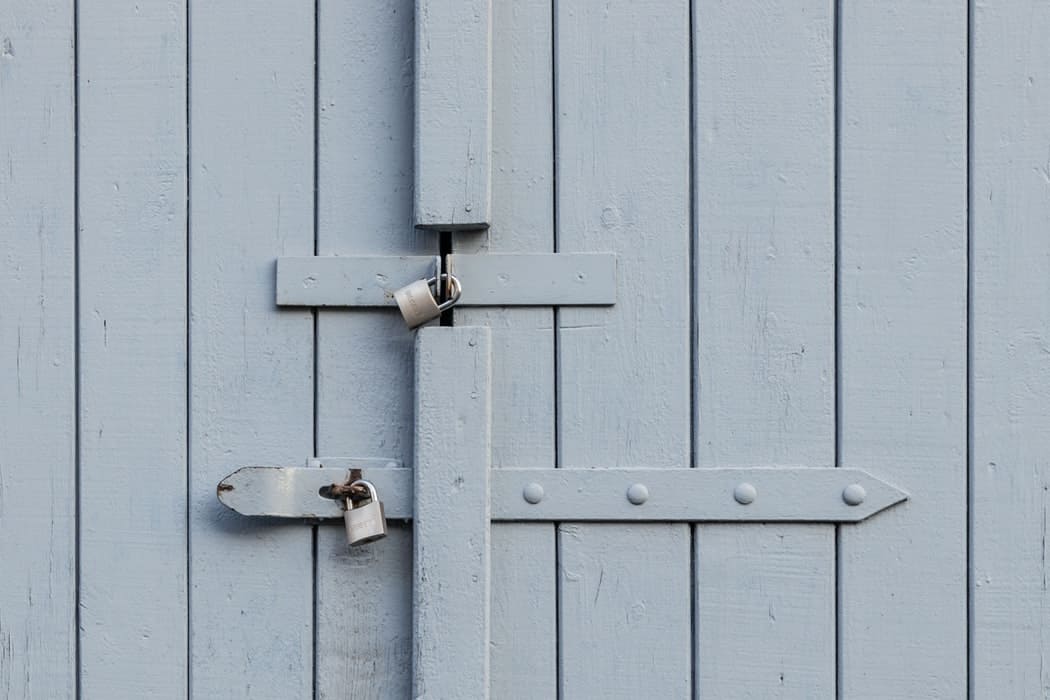 Two Padlocks on a blue wooden door