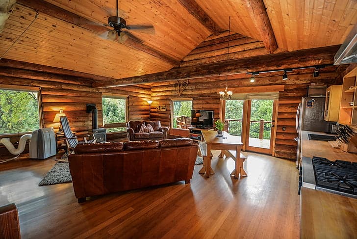 Wooden farmhouse interior with logs and vintage furnishings