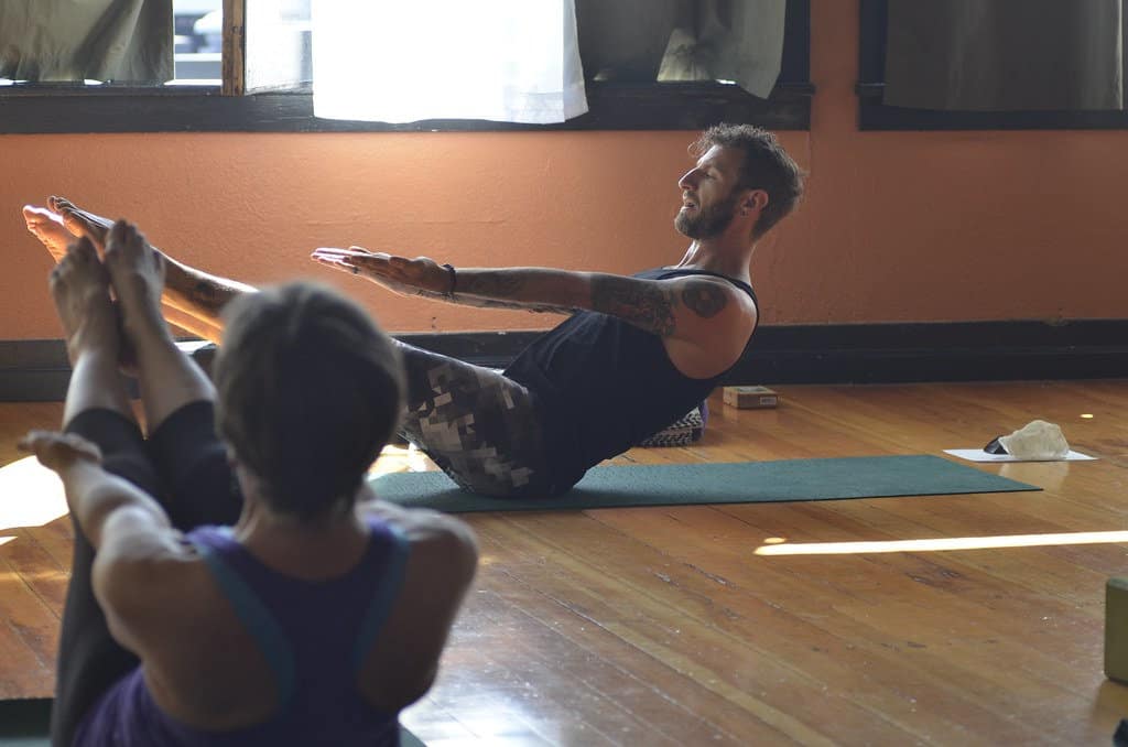 A yoga teacher leading an all levels yoga class