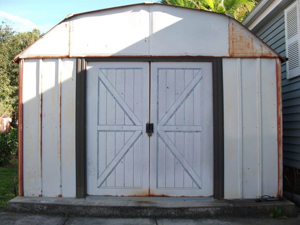 White shed with barn-like door