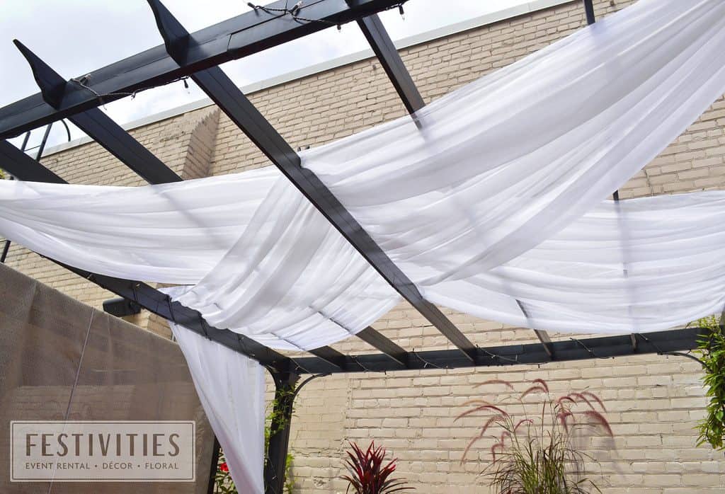 Rooftop patio canopy with sheer white curtains