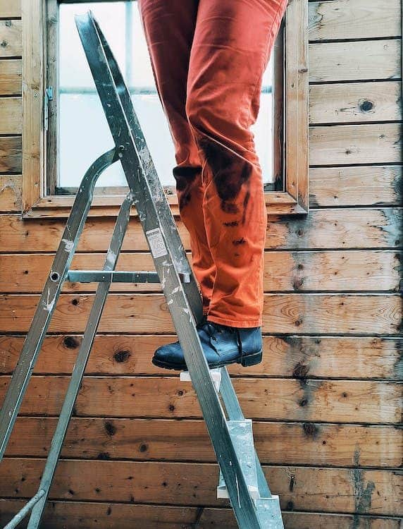 A man stepping on a ladder