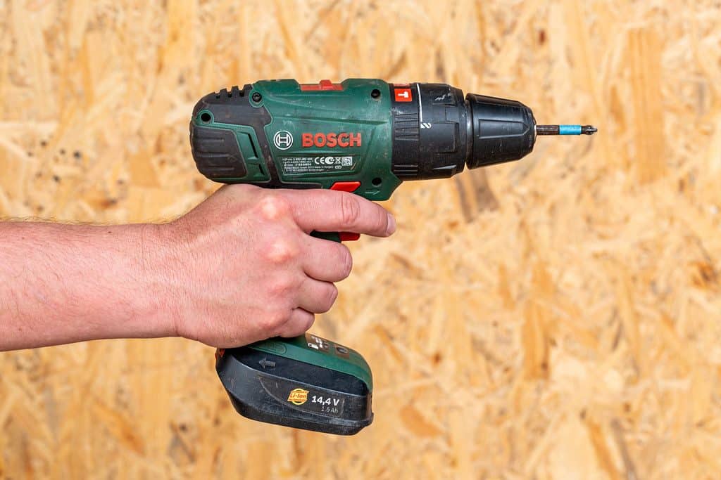 A man holding an electric drill