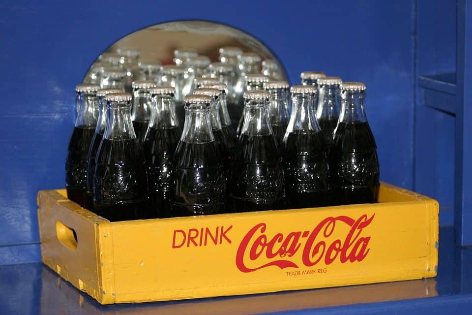 A crate full of glass Cola-cola drinks