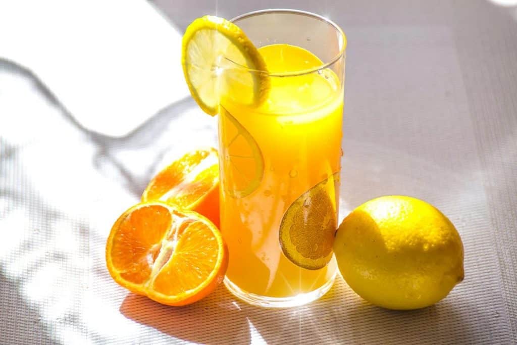 A lemonade glass with sliced tangerines