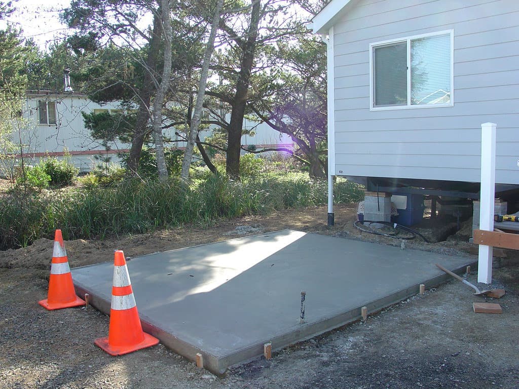 Concrete slab drying in a small backyard.