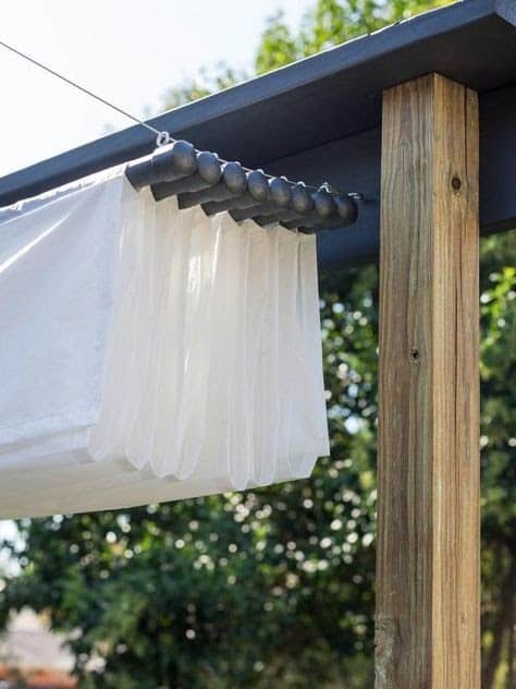 a white, thin canopy on a string in a garden that can be retracted