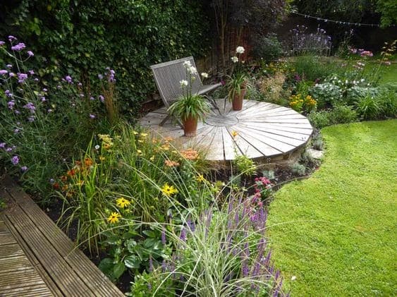 small wildlife meadow with raised circular deck and bench