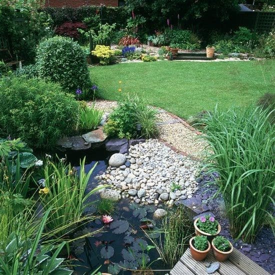 garden with tiered gravel and a pond