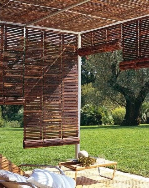 brown mahogany wooden pieces of material acting as blinds for some garden furniture in a garden making for a shady area 