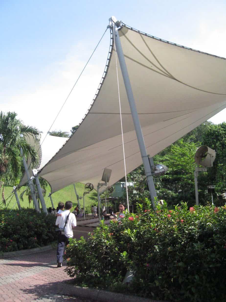 Large sun shade sail covering people and plants