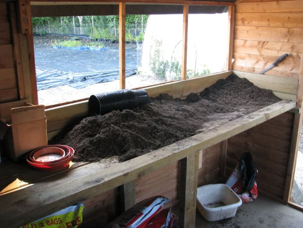 Potting bench filled with soil.