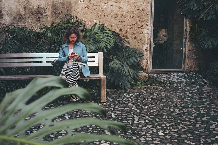 A woman sitting on a garden bench