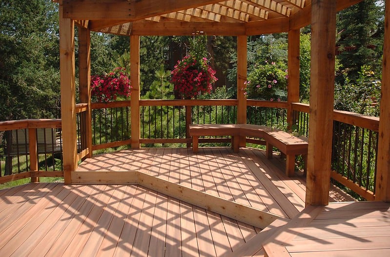 A sunny bench area on a wooden deck