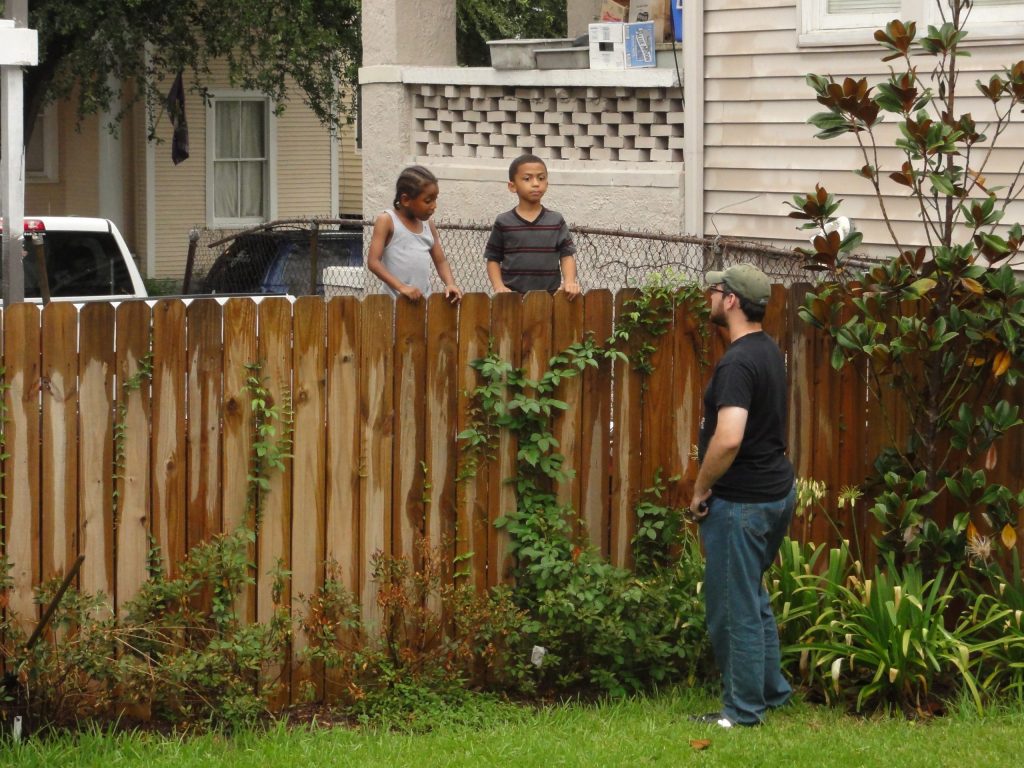 Wooden fence that separated two properties, neighbours conversing with each other