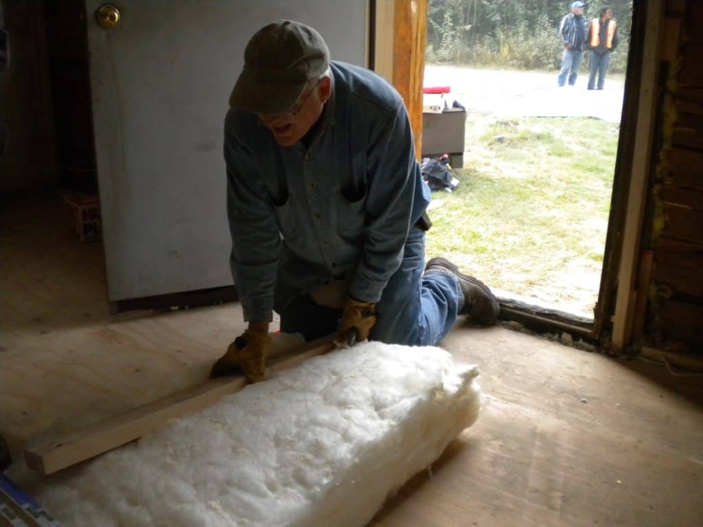 A man measuring flooring insulation