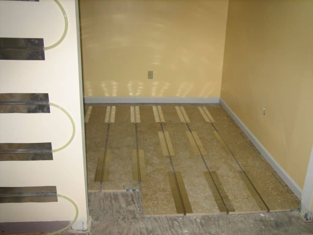 Installation of radiant floor heating on a floor surface.