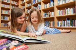 Girls reading on library floor