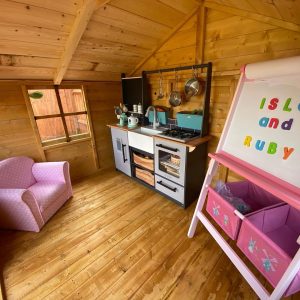 Playhouse interior with childrens pink furniture
