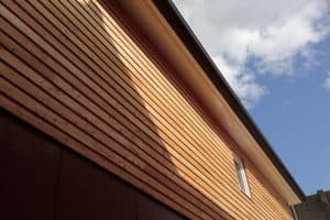 Dark timber cladding on large building