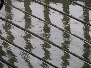 Rain water on dark wood planks