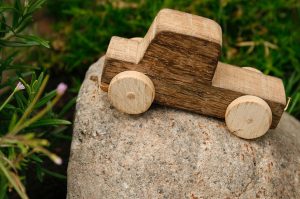 A wooden toy on a rock