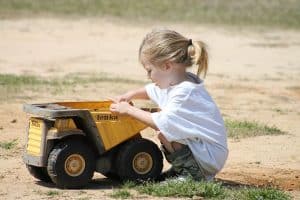 A girl playing with a toy by herself