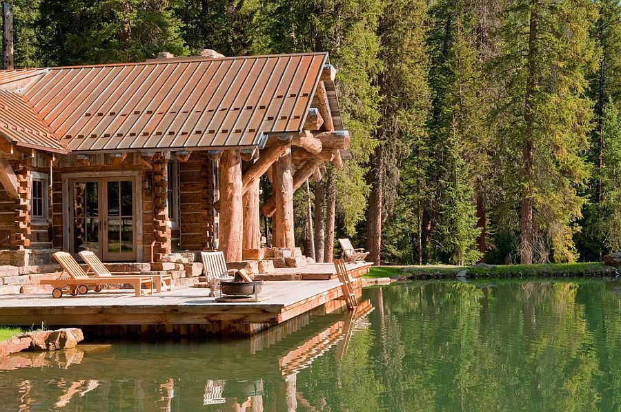 Insulated log cabin with rustic patio deck with a view of the lake