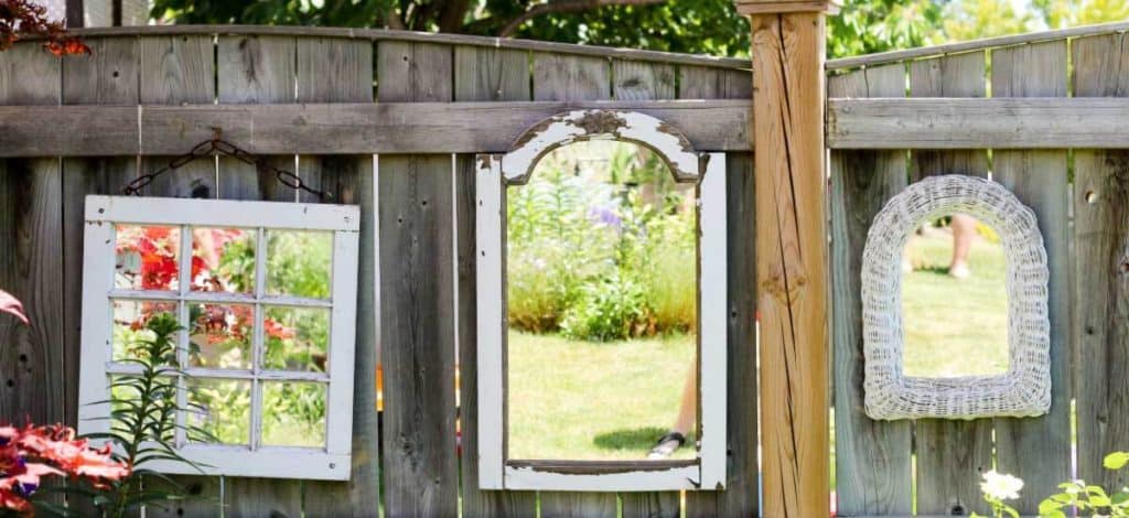 Creatively layered garden mirrors