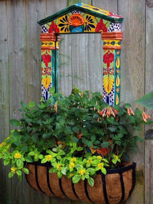 Small garden mirror with a burst of colour