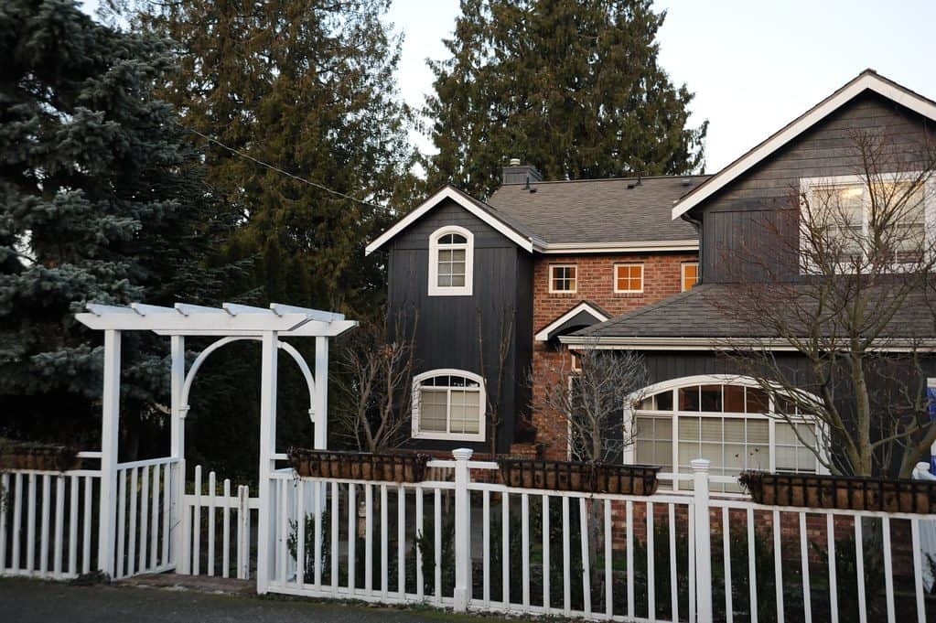 White fencing with an arbour and mini gate