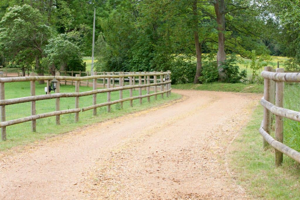 Long rail wooden fencing in a farm setting