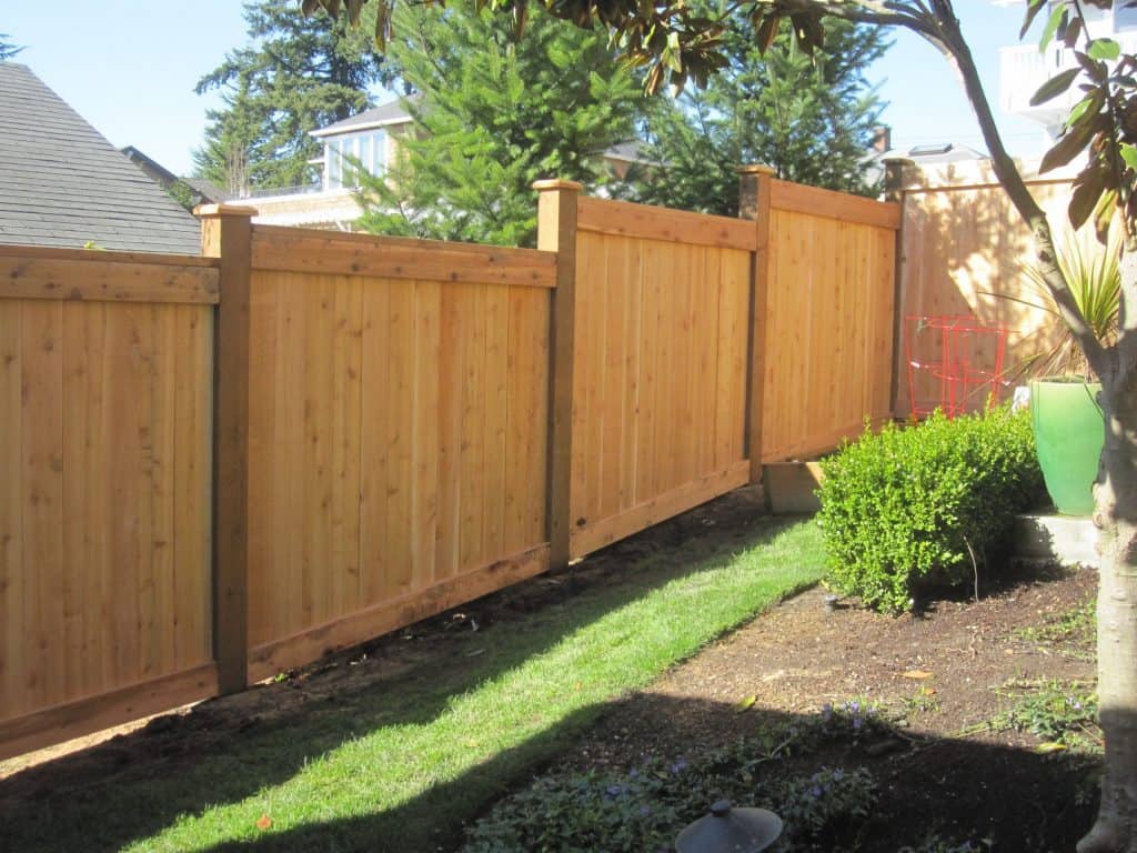 Stepped wood scaled garden fence
