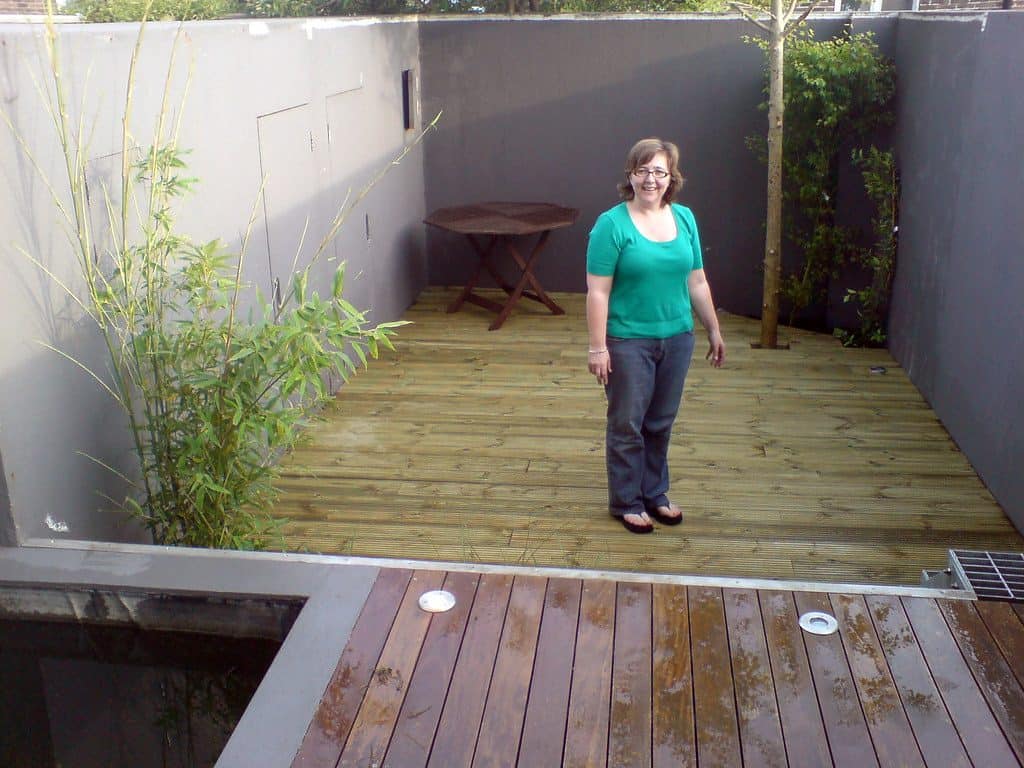 A woman posing on her new garden deck