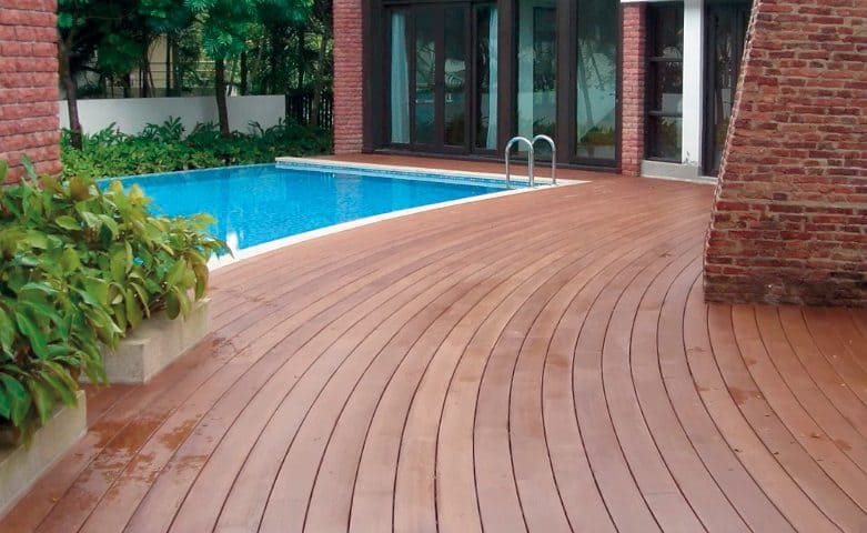 Backyard swimming pool with side wooden deck