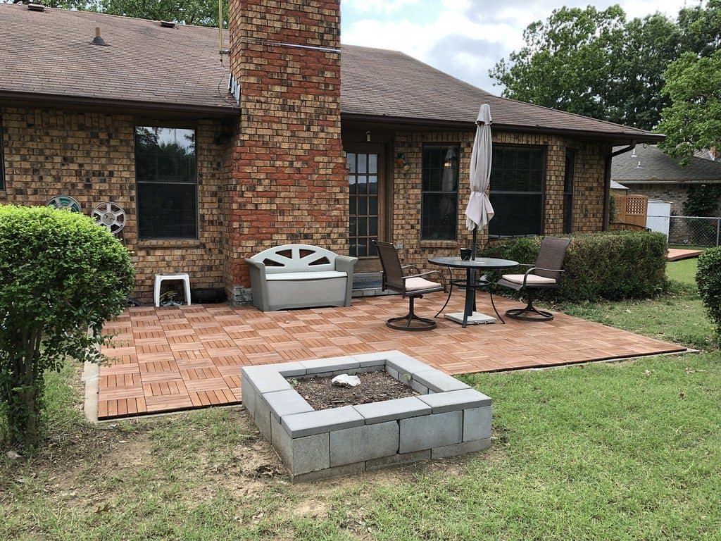 Parquet mini backyard patio with stone fireplace and chimney