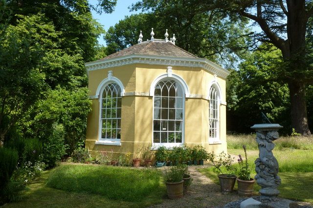 Octagonal yellow summer house design with big glass window panels