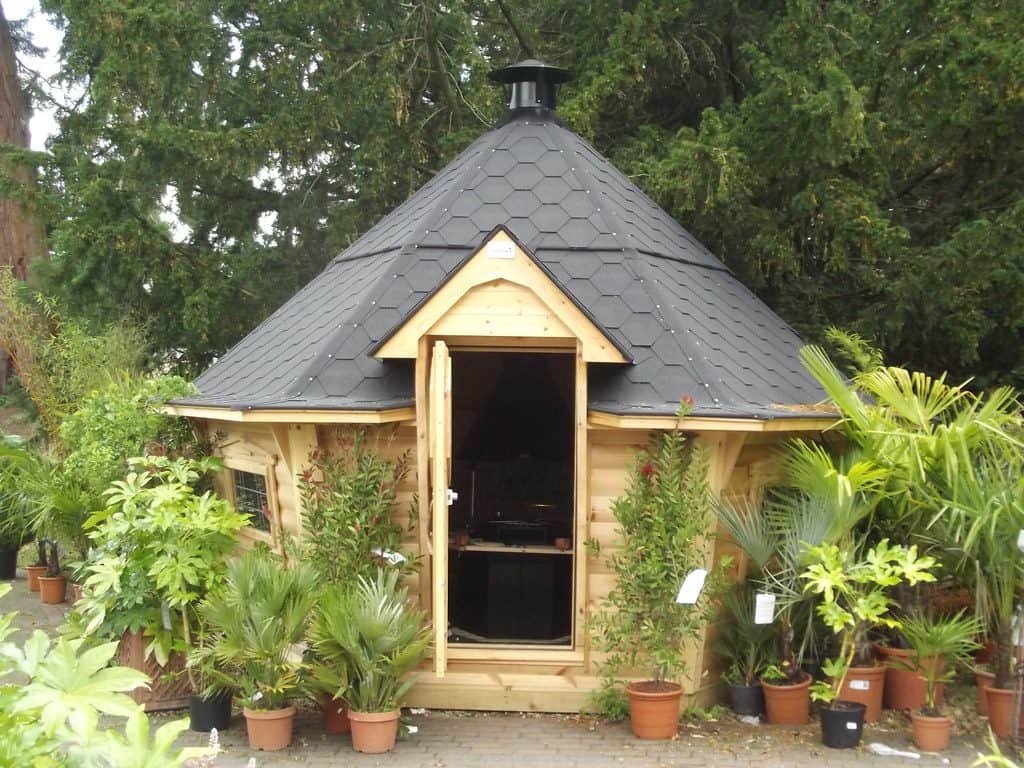 Cottage fairy-inspired mini summerhouse with potted plants landscape
