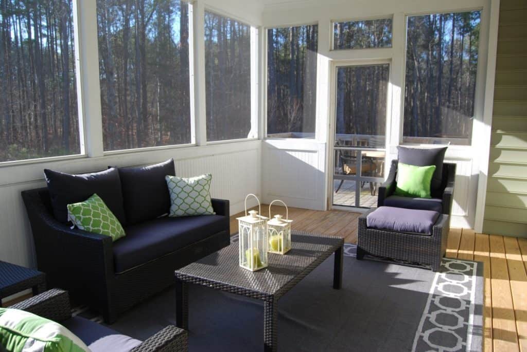 Sunroom porch with seating area and laid rug