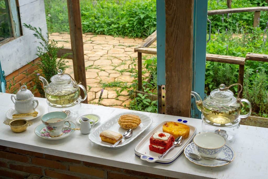 Simple garden tea party setup with vintage teapots and teacups