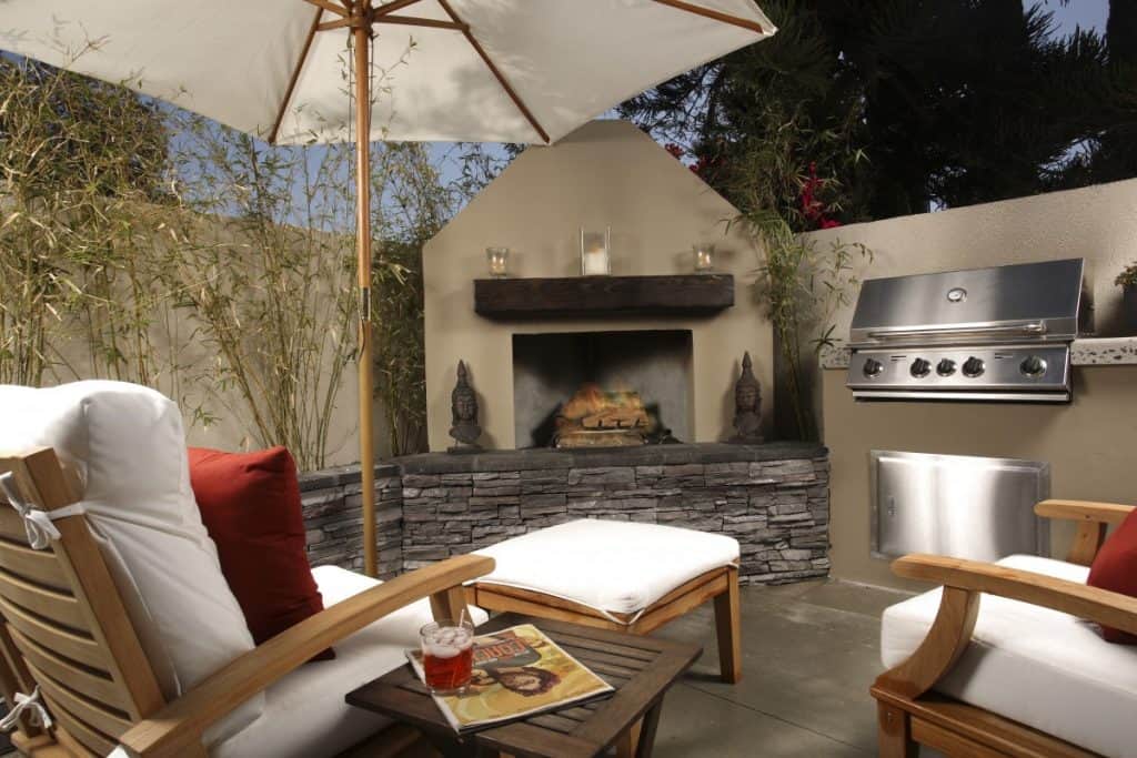 Small shaded patio with a fireplace and BBQ grill areas