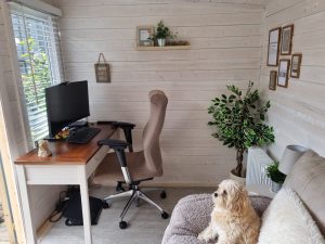 Garden room interior with computer workspace and cream walls.