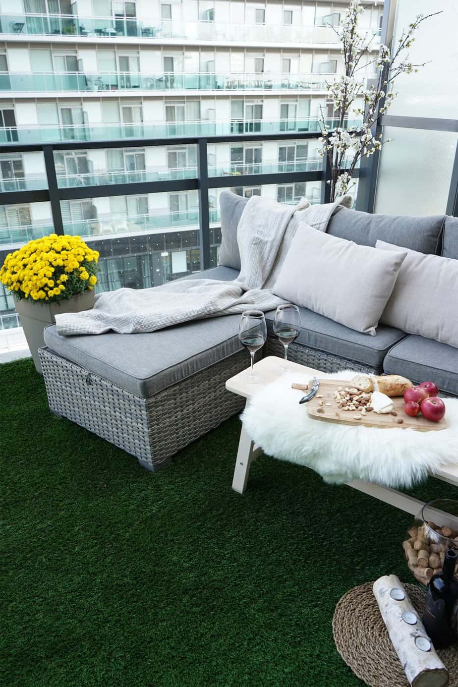 Artificial turf on a balcony with rattan furniture