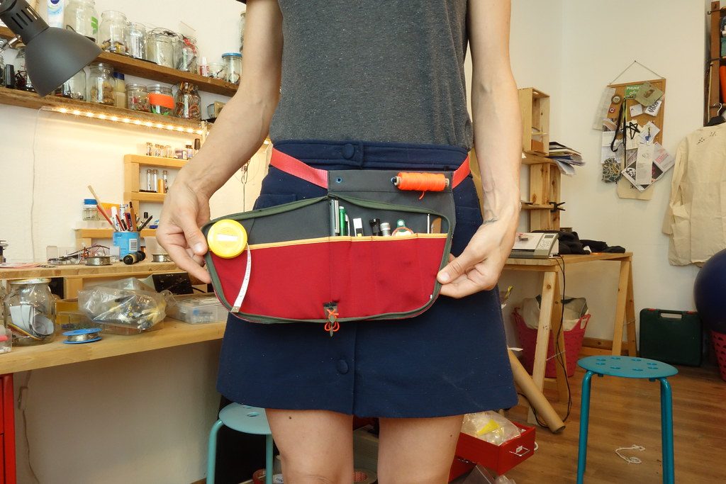 A person wearing an unzip tool apron