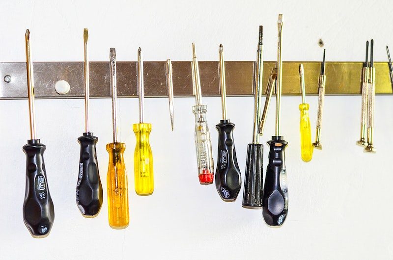 Screwdrivers and household tools on a magnetic strip