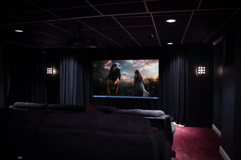 Home theatre, mild HDR (+/-2 ev) of room composed with freeze frame shot of screen in action